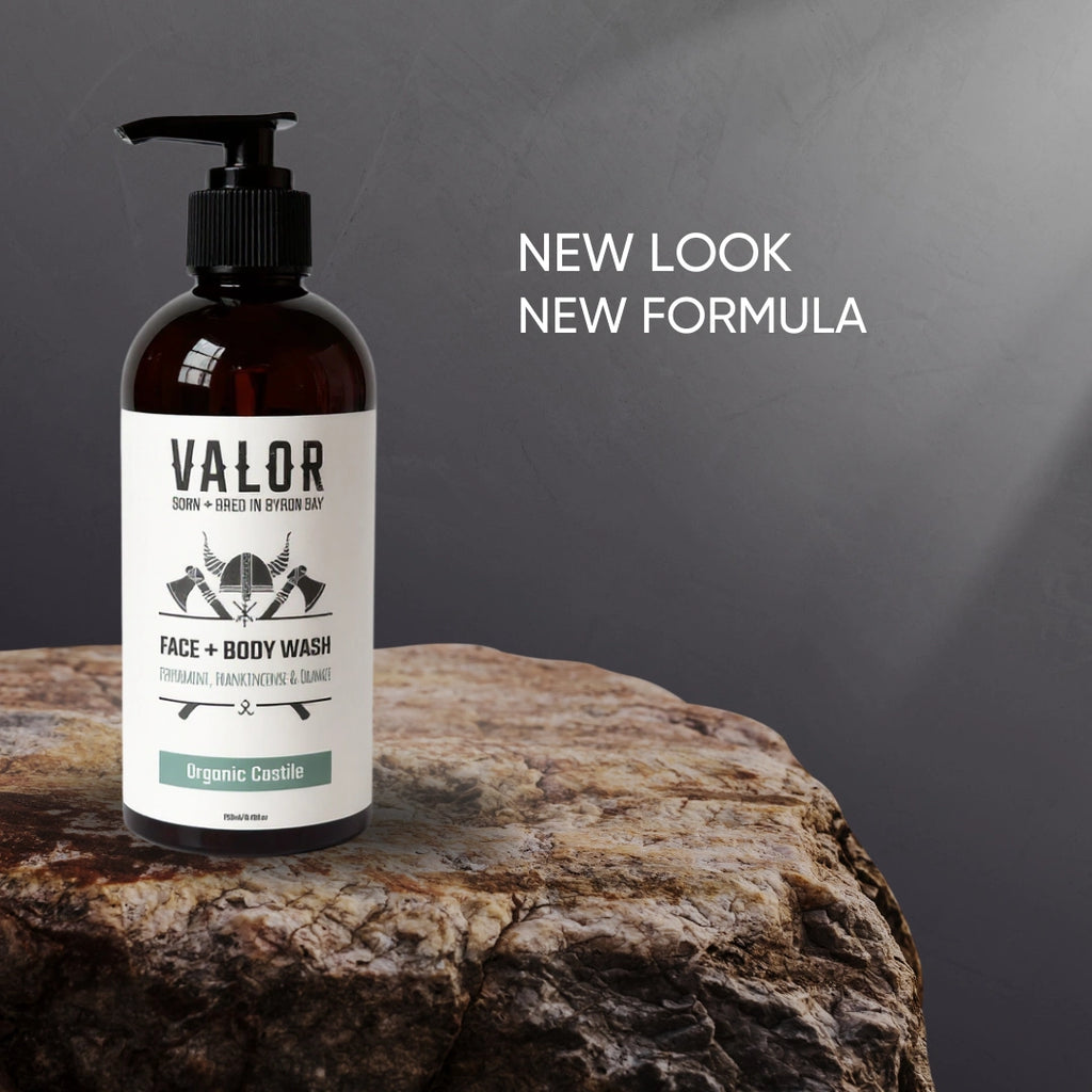 Bottle of Valor face and body wash on a stone surface with a gray background