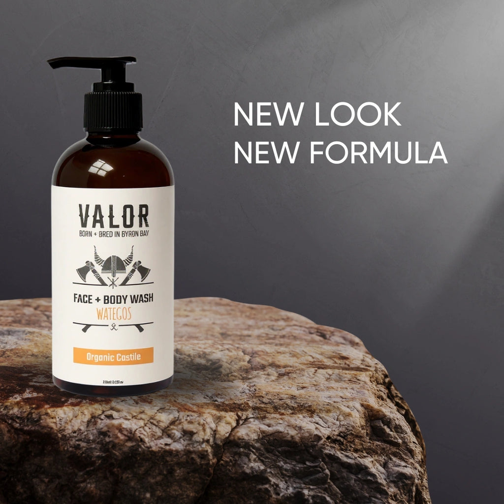 Bottle of Valor Face + Body Wash on a wooden surface with a gray background